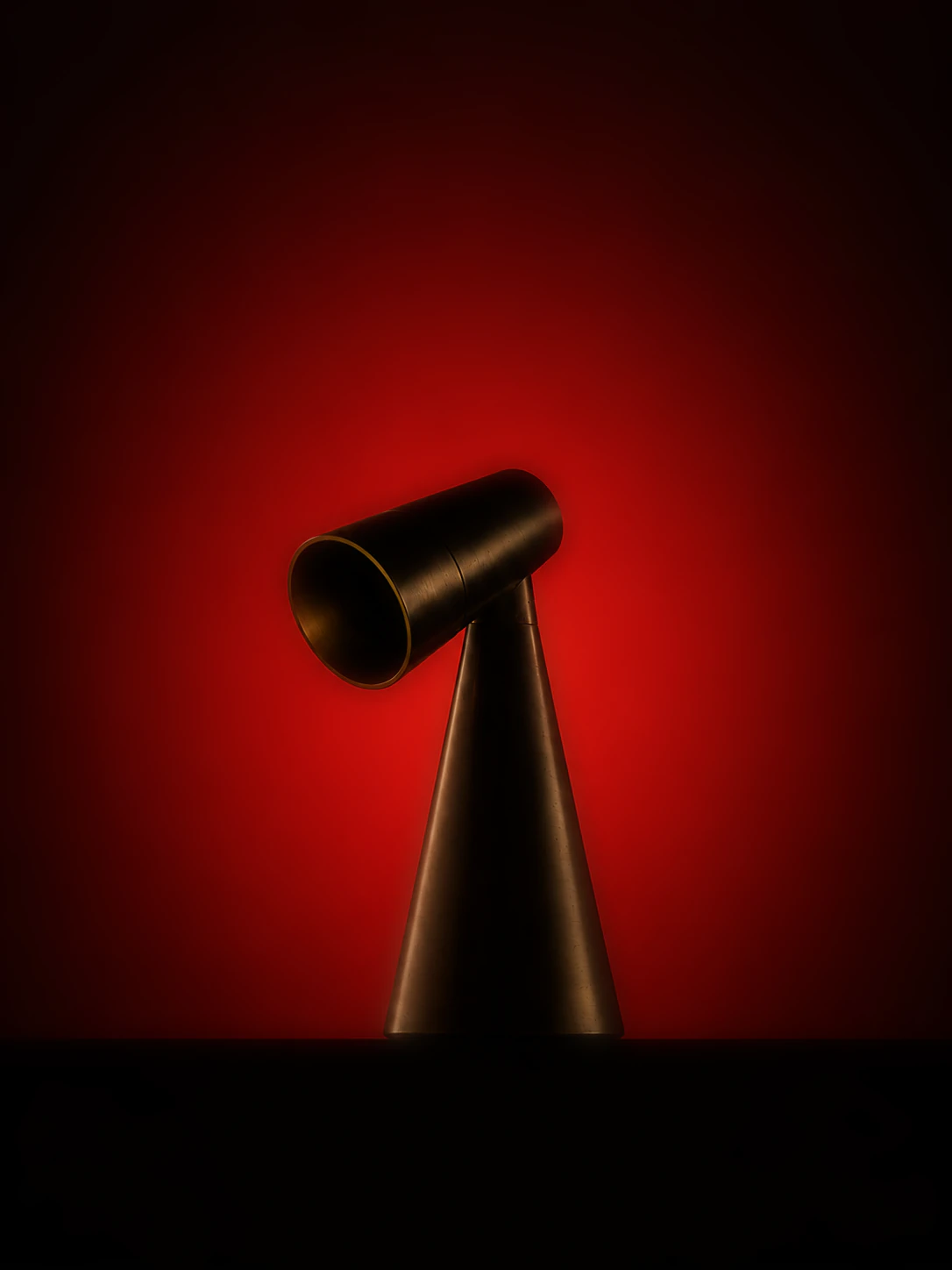 Milieu Table Lamp 001 silhouetted against a red glow