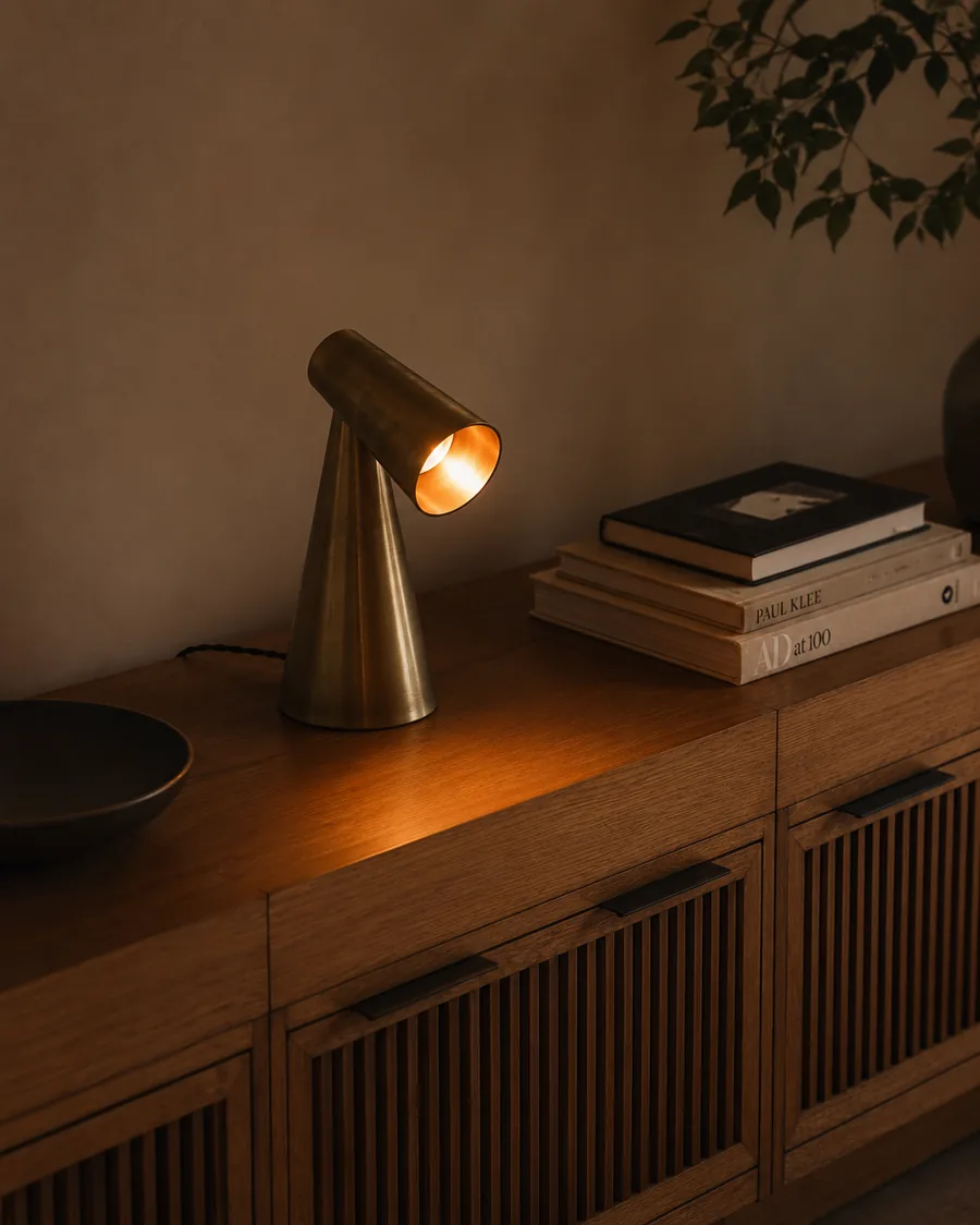 Milieu lamp on a lived-in credenza at dusk